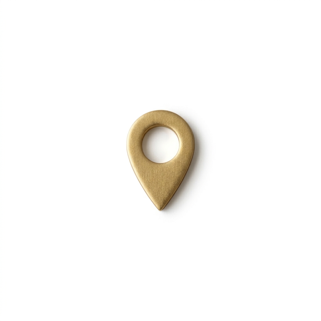 Gold location pin icon centered on beige surface